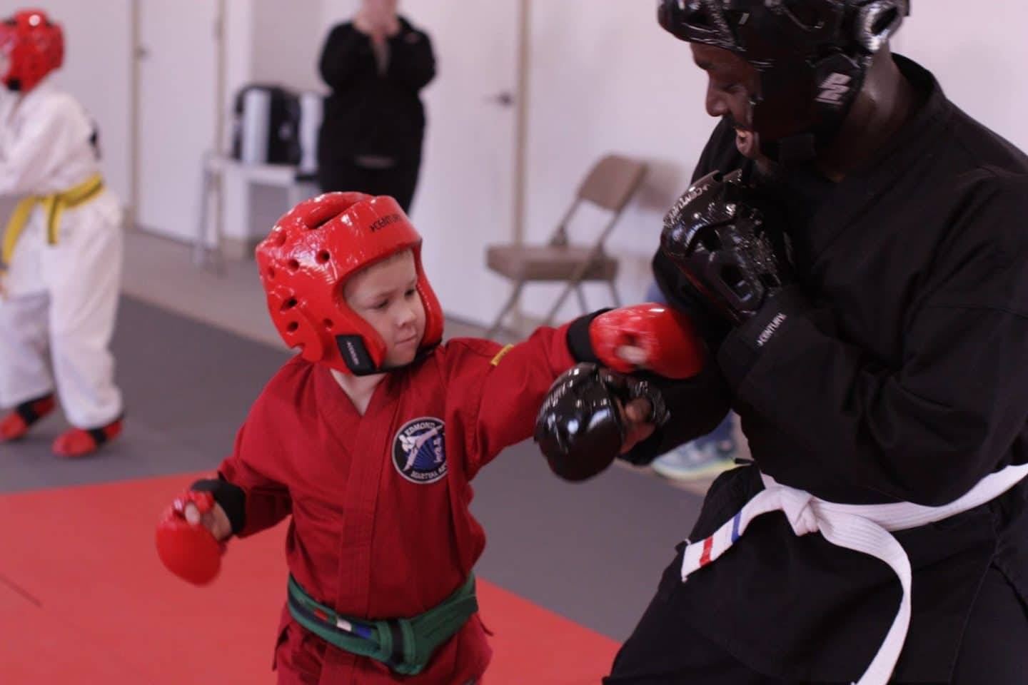 very young student practicing sparring with instructor